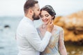 Same couple with a bride in a blue dress walk