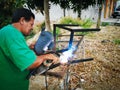 Same, ECUADOR, 10 October 2019: Unidentified welder on a side road, welding together two pieces of metal