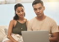 Same with moving to a new house. It keeps the balance. Shot of a couple using a laptop at home. Royalty Free Stock Photo