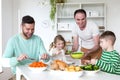 Same sex couple having dinner with children