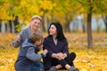 Same sex female couple with son in autumn park. Royalty Free Stock Photo