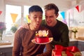 Same Sex Male Couple Celebrating 30th Birthday At Home With Cake And Presents