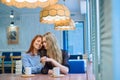 Same-sex relationships. Happy lesbian couple sitting in a cafe. Girls gently hold hands and drink coffee. Embrace of Royalty Free Stock Photo