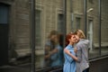 Same-sex relationships. Portrait of two young lesbians stand on the street and kiss. A young woman passionately presses Royalty Free Stock Photo