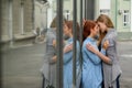 Same-sex relationships. Portrait of two young lesbians stand on the street and kiss. A young woman passionately presses Royalty Free Stock Photo