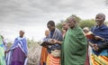 Maasai people singing and reading Bible