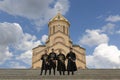 Sameba Cathedral with people in local costumes, Tbilisi, Georgia