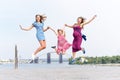 Samesex lesbian family with child on a walk in the park near the river. Lesbians mothers with adopted child, happy Royalty Free Stock Photo