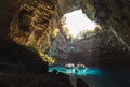 Sami, Greece - October 3, 2022: Melissani Cave Lake with floating boats with tourists in Sami, Greece