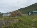 Sami village Staloluokta at Virihaure lake with houses and cottage, mountains and birch trees. summer moody and foggy Royalty Free Stock Photo