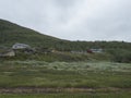 Sami village Staloluokta at Virihaure lake with houses and cottage, mountains and birch trees. summer moody and foggy Royalty Free Stock Photo