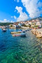 Fishing boats in Kokkari port with colourful Greek houses, Samos island, Greece Royalty Free Stock Photo