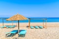 Sun chairs with umbrellas on Potami beach, Samos island, Greece Royalty Free Stock Photo