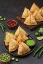 Samosa or samboosa with sauce, lime and black background Royalty Free Stock Photo