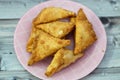 A samosa Singara, a fried South Asian pastry with a Savoury filling including ingredients like spiced potatoes, onions, peas, meat