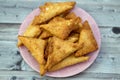 A samosa Singara, a fried South Asian pastry with a Savoury filling including ingredients like spiced potatoes, onions, peas, meat