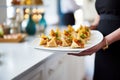 samosas on a platter being served at a party Royalty Free Stock Photo