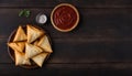 Samosas on Wooden Plate with Sauces and Copy Space