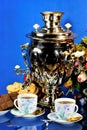 Samovar-tea drinking from cups, sweet food cookies and chocolate. Samovar represents well-being, family comfort and prosperity, a
