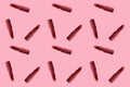 Sample background texture of many tubes of lipstick in pop art style on a pink background, concept decorative cosmetics Royalty Free Stock Photo