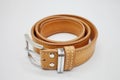Sample of brown leather men`s belt with metal shiny handmade buckle, stitched on the edge, hand craft concept Royalty Free Stock Photo