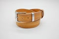 Sample of brown leather men`s belt with metal shiny handmade buckle, stitched on the edge, hand craft concept Royalty Free Stock Photo