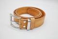 Sample of brown leather men`s belt with metal shiny handmade buckle, stitched on the edge, hand craft concept Royalty Free Stock Photo