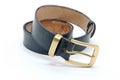 sample of classic leather men`s belt with metal shiny buckle handmade in black twisted into a ball Royalty Free Stock Photo