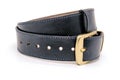 Sample of classic leather men`s belt with metal shiny buckle handmade in black twisted into a ball Royalty Free Stock Photo