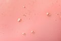 Sample of hydrophilic oil on pink background, top view