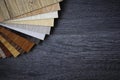 Sample pack of wooden flooring laminate on wooden black floor Royalty Free Stock Photo