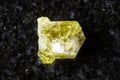 sample of raw chrysoberyl mineral on black granite Royalty Free Stock Photo