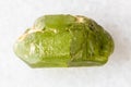 sample of raw peridod crystal on white marble Royalty Free Stock Photo