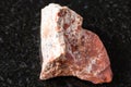 sample of raw red jasper rock on black granite Royalty Free Stock Photo