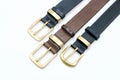 sample of several colors, black, brown, leather men`s belt with metal shiny buckle handmade Royalty Free Stock Photo