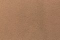 Sample of a texture of brown plaster. Wall finished with a decorative cement stucco. Example of exterior building decoration. Royalty Free Stock Photo