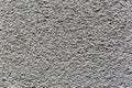 Sample of a texture of gray plaster. Wall finished with a decorative cement stucco. Example of exterior building decoration. Clean Royalty Free Stock Photo