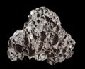 Sample of Volcanic Black Lava isolated on black background. Mineral of volcanic origin Royalty Free Stock Photo