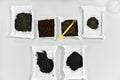 samples of black earth lie on a white table in a laboratory top view one