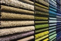 Samples of carpets of different colors on a stand in a store or production. Multi-colored carpet samples on the floor Royalty Free Stock Photo