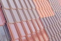 Samples of ceramic roofing tiles in a warehouse of a roofing mat