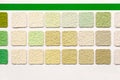 Samples of colored decorative plaster on the stand close-up Royalty Free Stock Photo