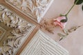 Corners of decorative wooden white frames and rose on beige canvas backdrop. Framer workshop concept. Royalty Free Stock Photo