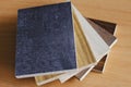 Samples of laminate with stone and wood texture on wooden Background for home renovate Royalty Free Stock Photo