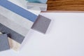 Samples of materials for interior design. Fabric wallpaper, samples of artificial stone, wood