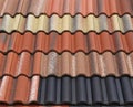 Samples of mineral fiber roof tiles, in the shape of traditional roof tiles, on display.