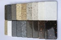 Samples of natural granite, marble, quartz stone, countertops and a sample of natural parquet. Model made of stones Royalty Free Stock Photo