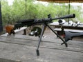 Samples of Soviet automatic weapons of the second world war. Machine guns and machine guns on a wooden table outside on a summer d