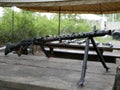 Samples of Soviet automatic weapons of the second world war. Machine guns and machine guns on a wooden table outside on a summer d