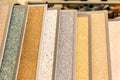 Samples of various multi-colored decorative plasters material for interior design in a hardware store Royalty Free Stock Photo
